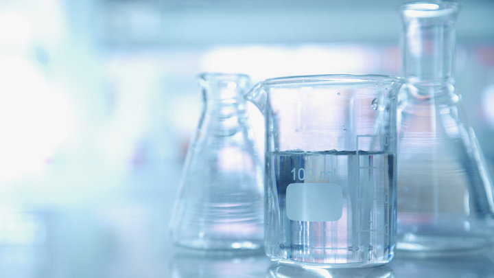 Lab glassware is seen on a table.