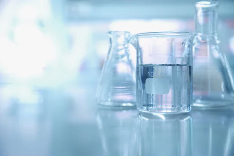 Lab glassware is seen on a table.